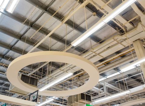 Ceiling mounted Lamps pipes and air ducts and communication system in the hall