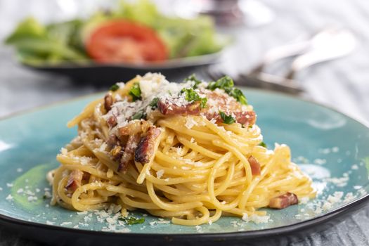 spaghetti carbonara on a blue plate