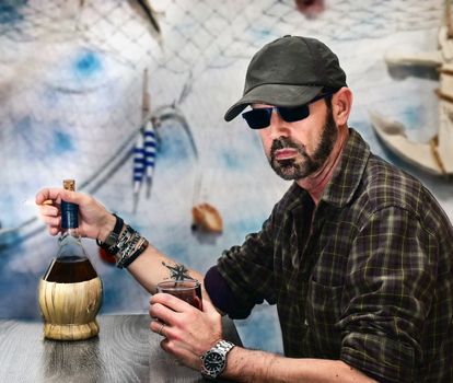 sea ​​man drinking wine in the port canteen