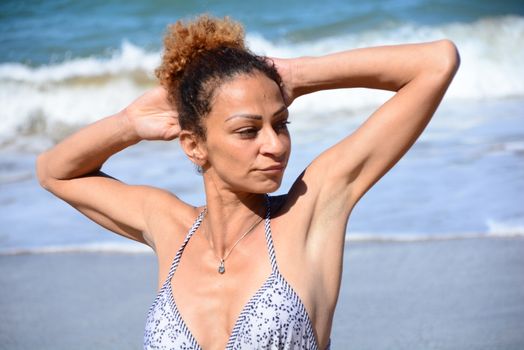 Photo shoot on the beach of a middle-aged woman in a sunny day