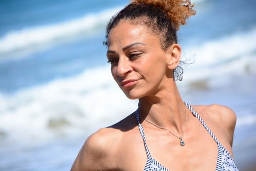 Photo shoot on the beach of a middle-aged woman in a sunny day
