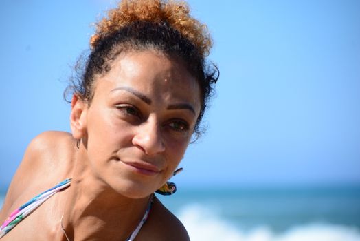 Photo shoot on the beach of a middle-aged woman in a sunny day