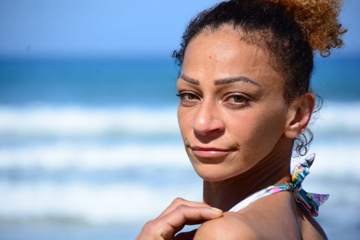 Photo shoot on the beach of a middle-aged woman in a sunny day