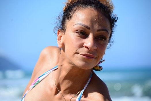Photo shoot on the beach of a middle-aged woman in a sunny day