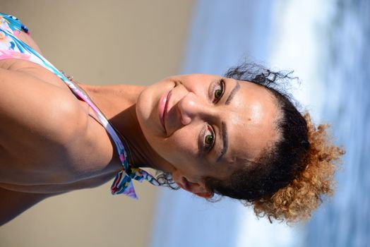 Photo shoot on the beach of a middle-aged woman in a sunny day