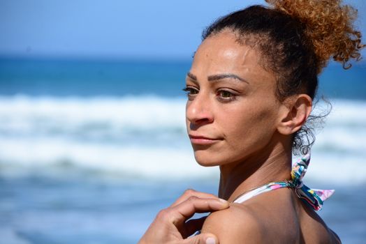 Photo shoot on the beach of a middle-aged woman in a sunny day
