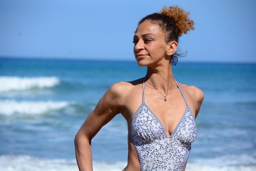 Photo shoot on the beach of a middle-aged woman in a sunny day
