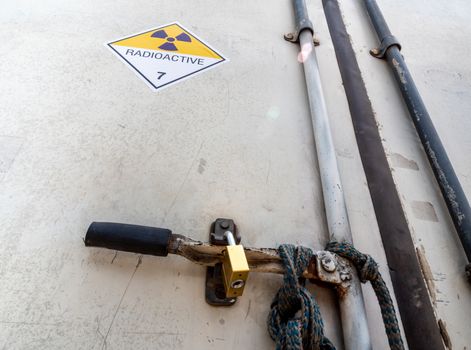 Radiation warning sign on the Hazardous materials transport label Class 7 at the aluminum container of transport truck