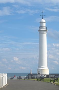 Lighthouse and park benchese along the promenade at Seaburn in the north of England