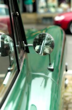Classic green sports car wing mirror