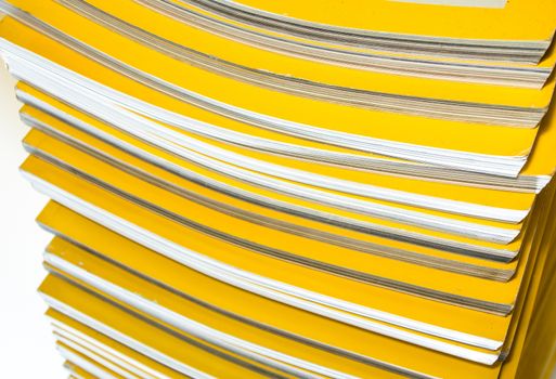 Stack of yellow color monthly magazine