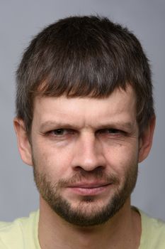 Close-up portrait of a suspicious man of European appearance