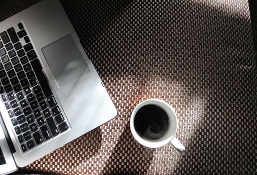 Laptop and a cup of coffee for work from home at the time of lock down during corona virus pandemic of 2020