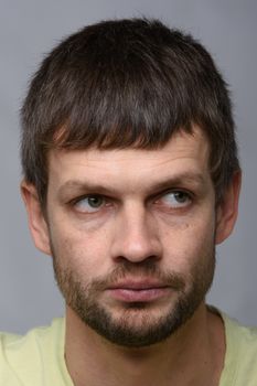 Portrait of a pensive man of European appearance looking away, close-up