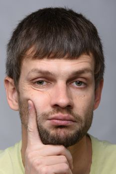 Closeup portrait of a sad and pensive man of European appearance