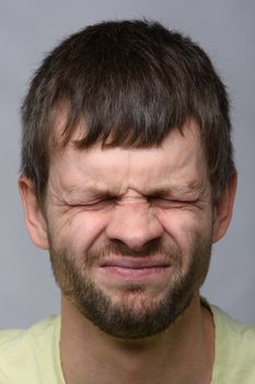 Close-up portrait of a squinted eye of a man of European appearance