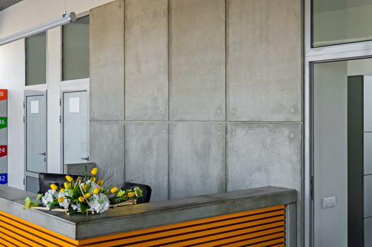 Gray-yellow modern counter on an internal entrance to metallurgical company.