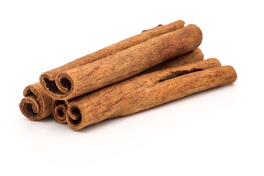 Three cinnamon sticks on a white background, isolated.