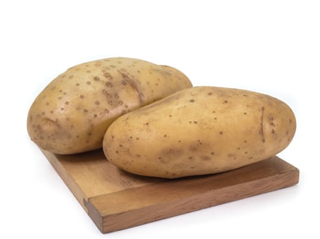 The close up of fresh organic potato vegetable on small wooden board on white background.