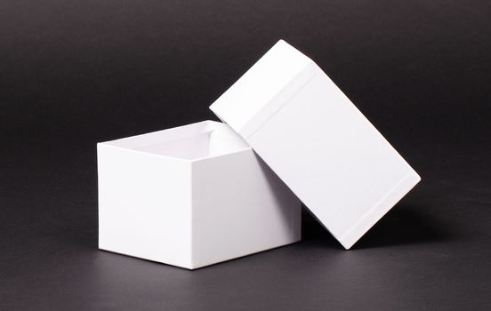 Opened blank White box isolated  on a black background