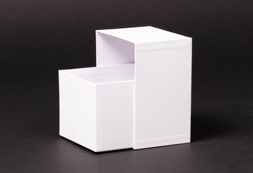 Opened blank White box isolated  on a black background