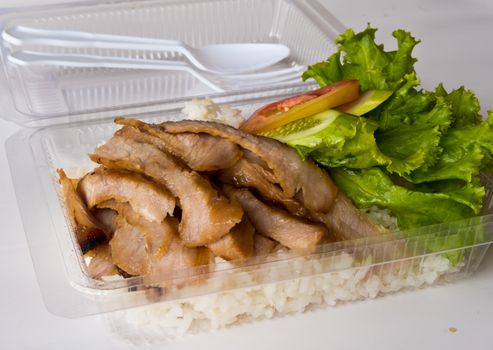 Roasted pork and rice in a plastic box