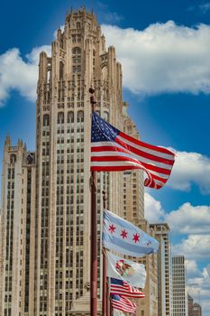 A line of flags in front of classic Chicago skyscraper