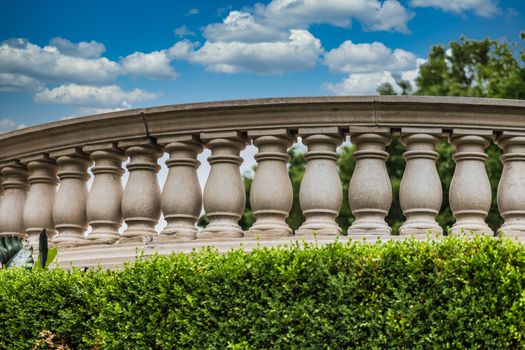 A curved cement balustrade in a public park