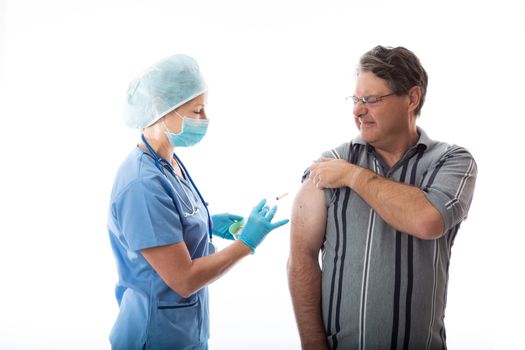 A man receives the influenza vaccine by a treatment nurse