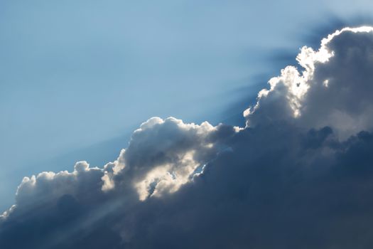 Sunbeam of the sun behind the clouds , sky background