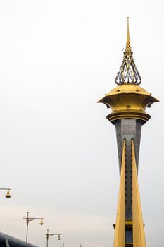 Beautifully decorated structure at the top of the tower of the bridge over the river