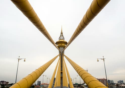 Beautifully decorated structure at the top of the tower of the bridge over the river