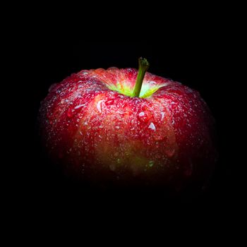 Close-up of Water droplet on glossy surface of freshness red apple on black background