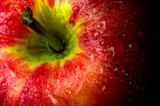 Close-up of Water droplet on glossy surface of freshness red apple on black background