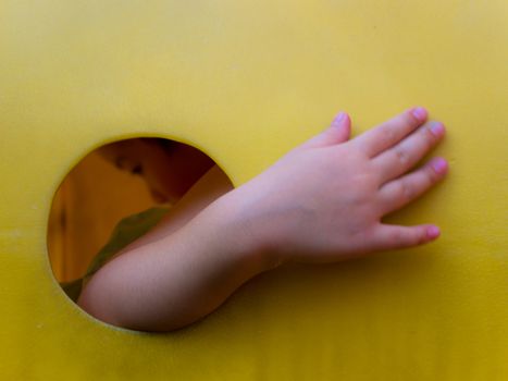 Asian little girl enjoys playing at children playground in leisure time