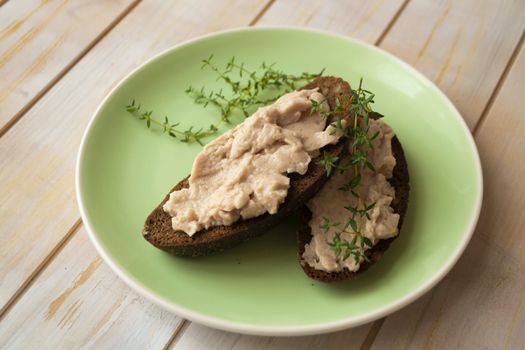 Slice of dark wheat bread and liver pate