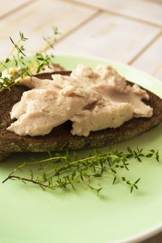 Sandwich with fresh chicken liver pate and micro greens, vertical