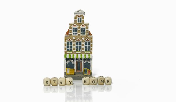 stay home due to coronavirus with a house on white background