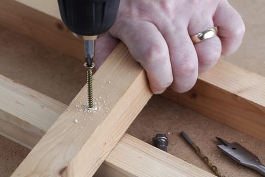 Drill screw and countersink wood on work-bench