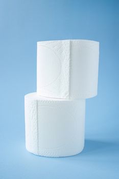 two Toilet paper roll on a blue background top view. Toilet paper purchase due to kronavirus concept. Personal hygiene and stopping the spread of the virus. Cleanliness, Hygiene, Sterility