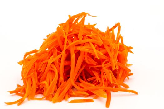 A bunch of grated carrots close-up on a white. Isolated