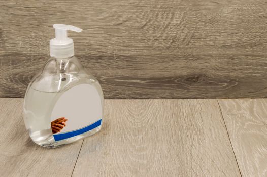 Hand sanitizer gel with alcohol disinfectant for the prevention of coronavirus on a gray wooden background