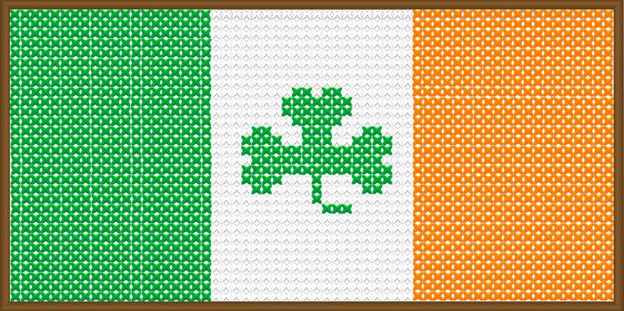 A cross stitch version of the flag of Ireland with a shamrock, with a frame..