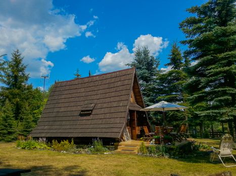 Wooden camping house in village at sunny cloudy day