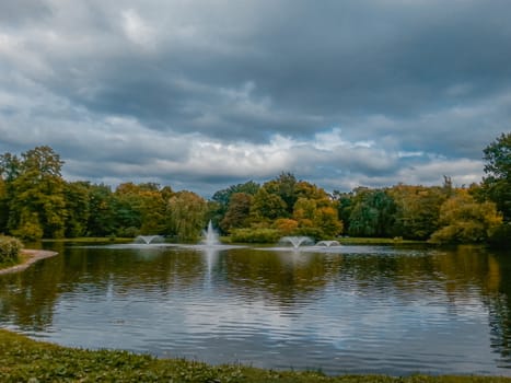 Fountains on great lake in south park in Wroclaw at colorful autumn