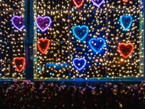 Colorful love decorations out of focus at night on bridge in Wroclaw