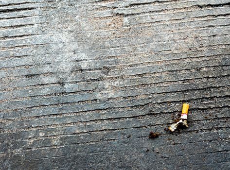 The cigarette butt let down on the concrete floor