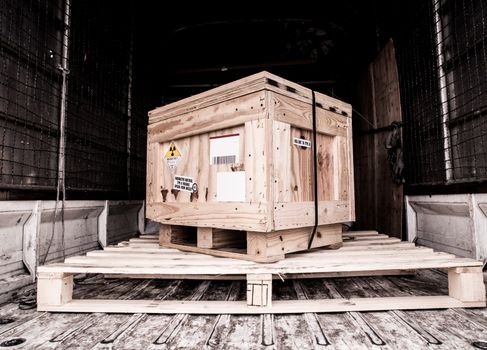 Radioactive material label beside the transportation wooden box Type A standard package in the truck