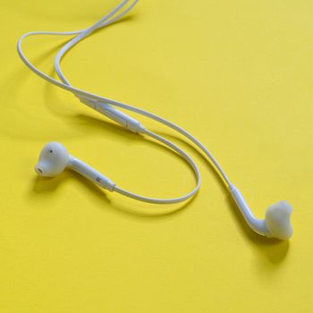 a pair of earphones on a yellow surface