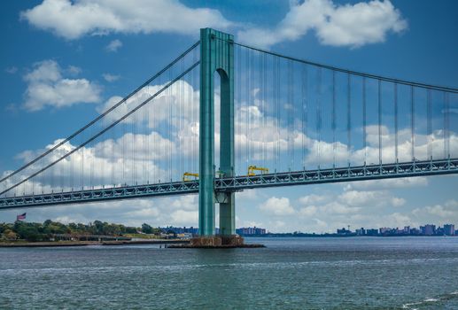 The Verrazano Bridge under blue skies on a foggy day in New York City